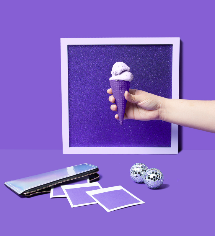 Ice cream held up to a frame in purple